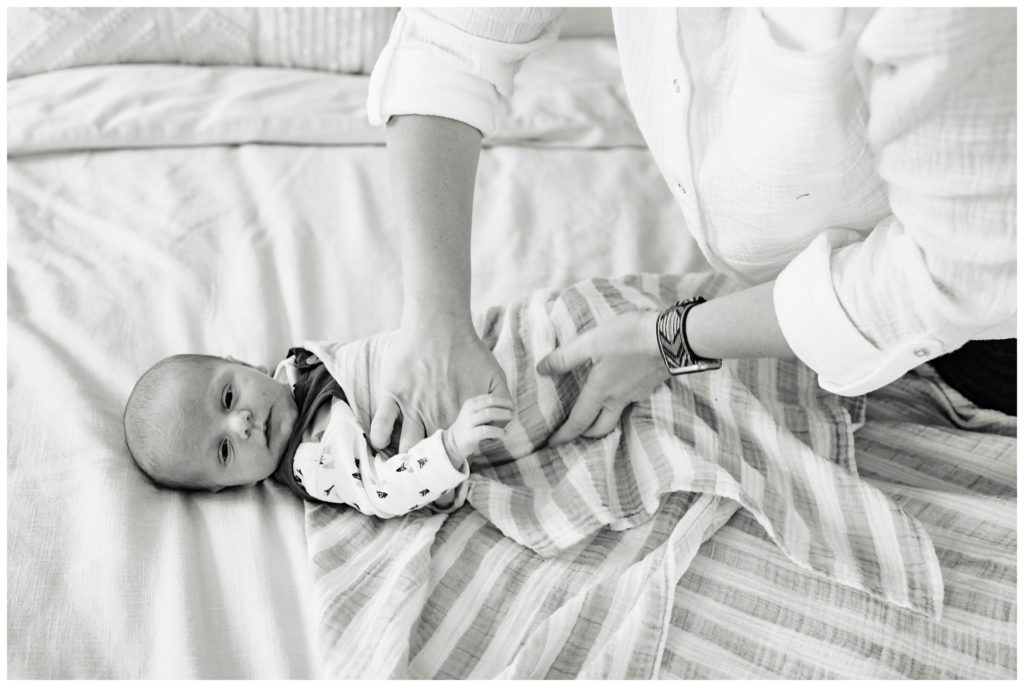 black and white newborn photo inhome on bed